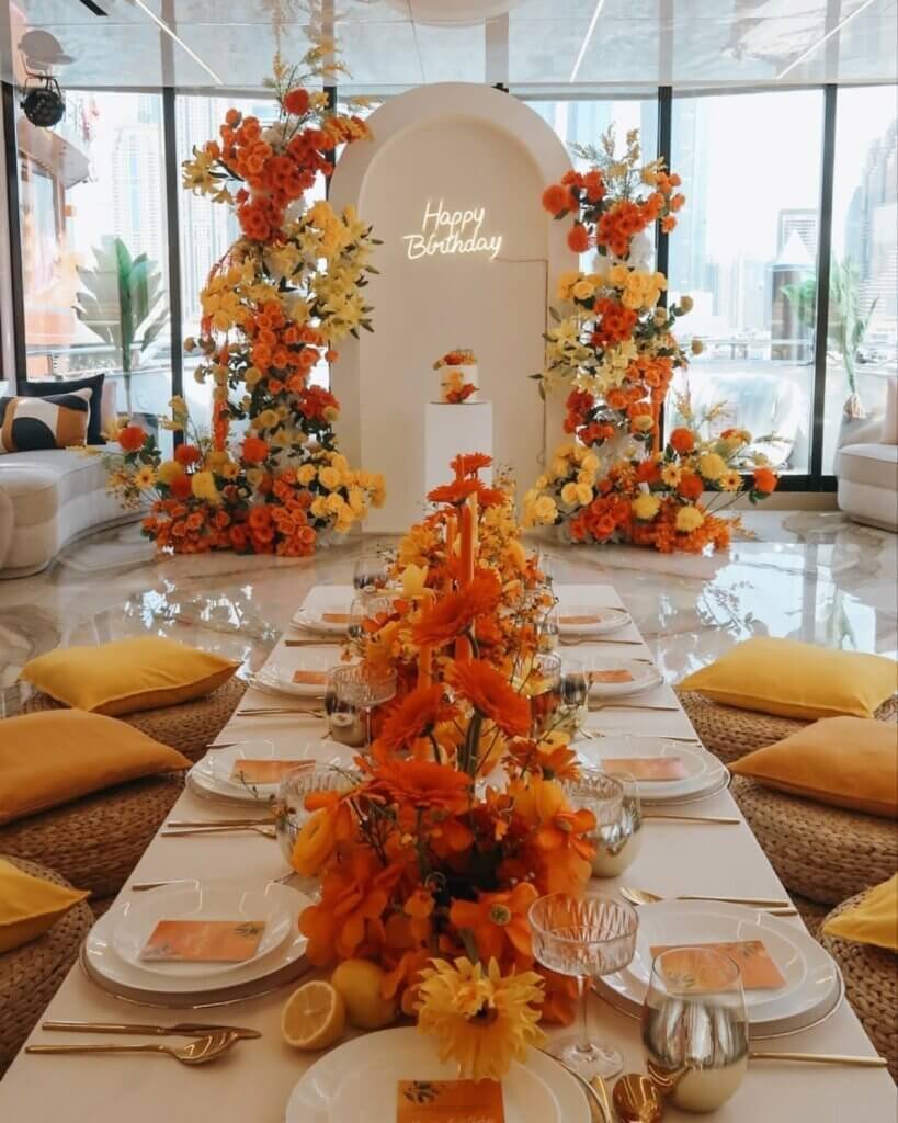 Sunset Luxe event décor featuring deep plum, terracotta, persimmon and brushed gold accents